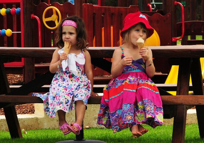 Children sitting quietly licking icecream