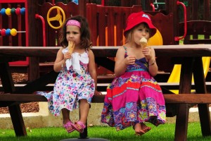 Children sitting quietly licking icecream