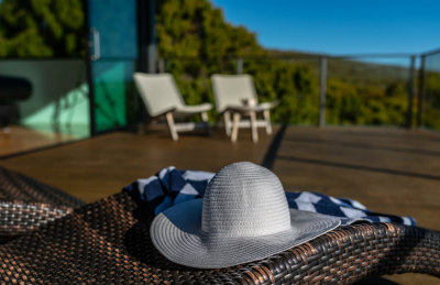 Outdoor chairs and sun hat on the balcony.