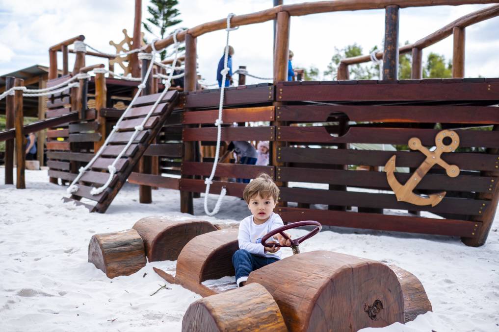 Young chiild playing in wooden car at Flinders Bay playground, Augusta